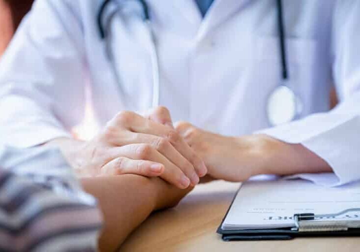 The doctor hands holding patient hand to encouragement